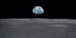 Asteroid impacts on the Moon are mirrored on Earth by a Lunar Glass